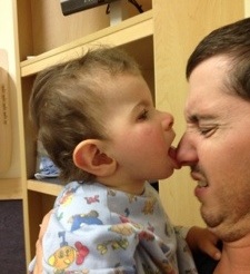 Trying to eat daddy's nose